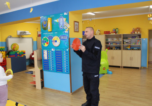Funkcjonariusz Policji podczas zabawy muzyczno - ruchowej