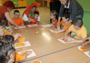 Dzień pomarańczowy - na zdjęciu przedszkolaki podczas malowania