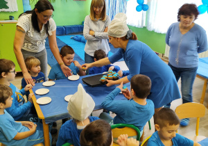 Dzień niebieski - przedszkolaki częstują się słodkimi babeczkami.